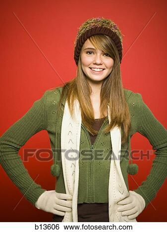 Stock Photograph - Casually Dressed girl in hat and scarf smiling. Fotosearch