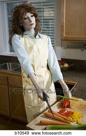 Stock Photo - Close-up of a female mannequin holding a knife in the kitchen. Fotosearch