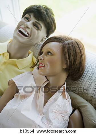 Close-up of a male mannequin and a female mannequin laughing on a couch View Large Photo Image Picture - Close-up of a male mannequin and a female mannequin laughing on a couch. Fotosearch