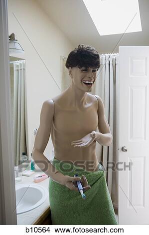Close-up of a male mannequin holding a toothbrush in the bathroom View Large Photo Image Picture - Close-up of a male mannequin holding a toothbrush in the bathroom. Fotosearch