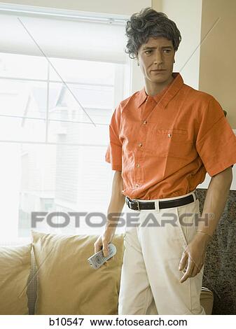 Close-up of a male mannequin holding a remote control View Large Photo Image Stock Photo - Close-up of a male mannequin holding a remote control. Fotosearch
