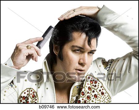 Close-up of a man combing his hair View Large Photo Image Stock Photograph - Close-up of a man combing his hair. Fotosearch