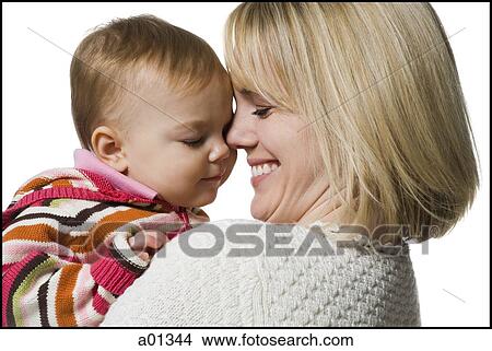 Close-up of a mother holding baby girl View Large Photo Image Picture - Close-up of a mother holding baby girl. Fotosearch