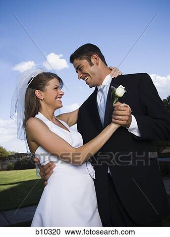 Stock Image - Close-up of a newlywed couple dancing. Fotosearch