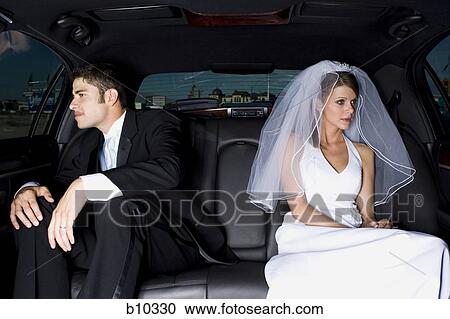 Close-up of a newlywed couple sitting in a car View Large Photo Image Stock Image - Close-up of a newlywed couple sitting in a car. Fotosearch