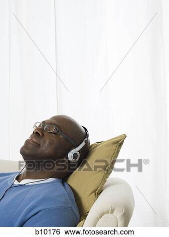 Close-up of a senior man wearing headphones and listening to music View Large Photo Image Stock Photograph - Close-up of a senior man wearing headphones and listening to music. Fotosearch