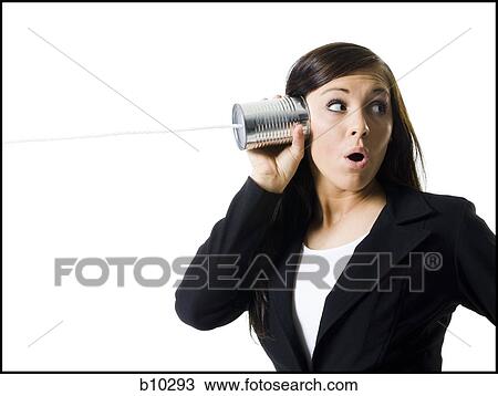 Close-up of a teenage girl holding a tin can phone up to her ear View Large Photo Image Stock Image - Close-up of a teenage girl holding a tin can phone up to her ear. Fotosearch
