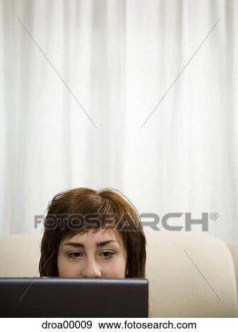 Close-up of a teenage girl using a laptop View Large Photo Image Stock Photo - Close-up of a teenage girl using a laptop. Fotosearch