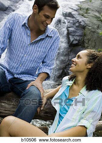 Close-up of a young couple embracing each other View Large Photo Image Stock Photograph - Close-up of a young couple embracing each other. Fotosearch