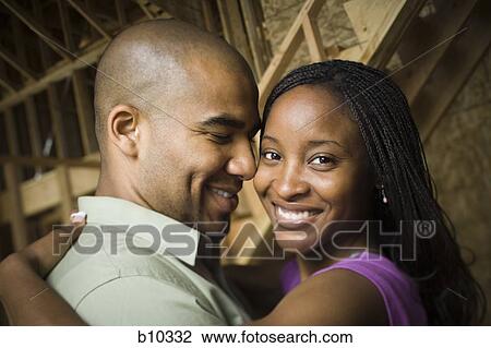 Stock Image - Close-up of a young couple smiling. Fotosearch
