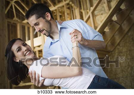 Close-up of a young couple smiling View Large Photo Image Stock Image - Close-up of a young couple smiling. Fotosearch