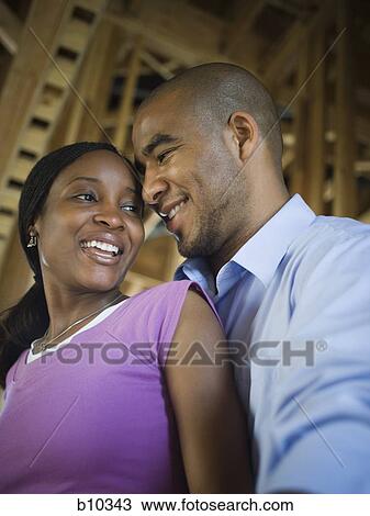 Close-up of a young couple smiling View Large Photo Image Stock Image - Close-up of a young couple smiling. Fotosearch