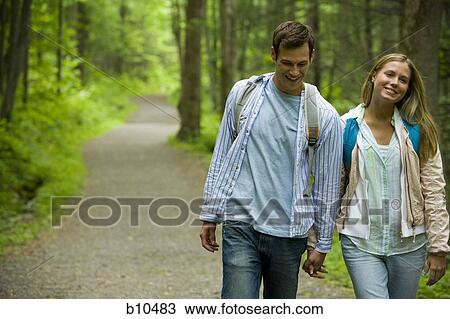Close-up of a young couple walking and holding hands View Large Photo Image Stock Image - Close-up of a young couple walking and holding hands. Fotosearch