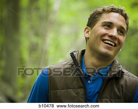 Close-up of a young man smiling View Large Photo Image Stock Photo - Close-up of a young man smiling. Fotosearch