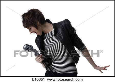 Close-up of a young woman holding a microphone and singing View Large Photo Image Stock Image - Close-up of a young woman holding a microphone and singing. Fotosearch