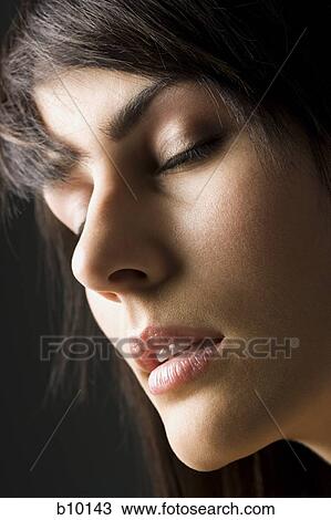 Close-up of a young woman with her eyes closed View Large Photo Image Stock Image - Close-up of a young woman with her eyes closed. Fotosearch