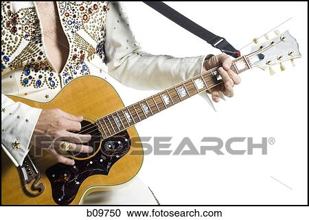 Close-up of an Elvis impersonator playing the guitar View Large Photo Image Stock Image - Close-up of an Elvis impersonator playing the guitar. Fotosearch