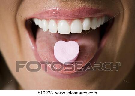 Close-up of candy on a young woman's tongue View Large Photo Image Stock Image - Close-up of candy on a young woman's tongue. Fotosearch