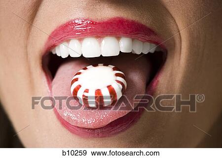 Close-up of candy on a young woman's tongue View Large Photo Image Stock Photo - Close-up of candy on a young woman's tongue. Fotosearch