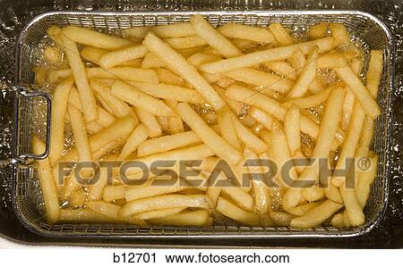 Stock Image - Close-up of French fries cooking. Fotosearch