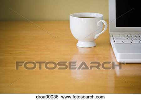 Stock Photograph - Close-up of laptop computer and coffee cup. Fotosearch