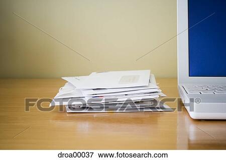 Close-up of laptop computer and mail View Large Photo Image Stock Photo - Close-up of laptop computer and mail. Fotosearch