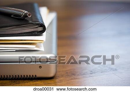 Close-up of laptop daytimer and papers on desk View Large Photo Image Stock Image - Close-up of laptop daytimer and papers on desk. Fotosearch