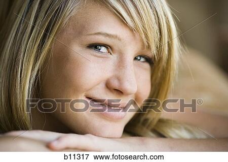 Close-up of smiling young woman View Large Photo Image Stock Photo - Close-up of smiling young woman. Fotosearch