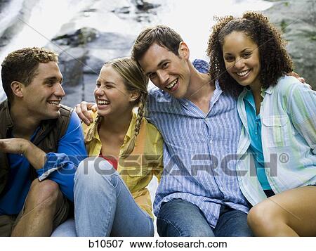 Close-up of two young women and two young men smiling View Large Photo Image Stock Photo - Close-up of two young women and two young men smiling. Fotosearch