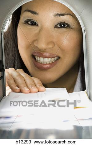 Close-up of woman getting letters from mailbox View Large Photo Image Stock Image - Close-up of woman getting letters from mailbox. Fotosearch