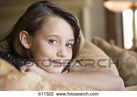 Stock Image - Close-up of young girl's smiling face. Fotosearch