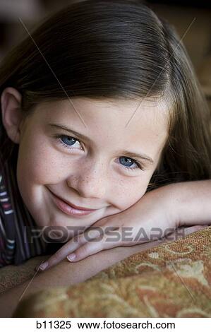 Stock Photography - Close-up of young girl's smiling face. Fotosearch