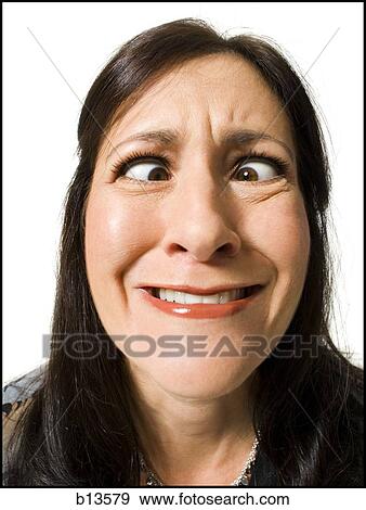 Closeup of woman with crossed eyes making funny face View Large Photo Image Stock Photo - Closeup of woman with crossed eyes making funny face. Fotosearch