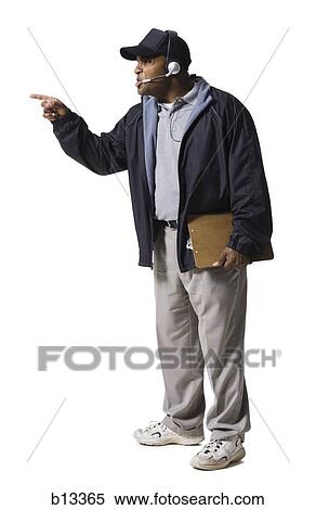 Stock Photography - Coach with clipboard and headset pointing. Fotosearch