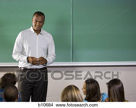 Picture - College teacher giving a lesson in classroom. Fotosearch