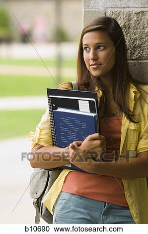 Stock Image - College teacher giving a lesson in classroom. Fotosearch