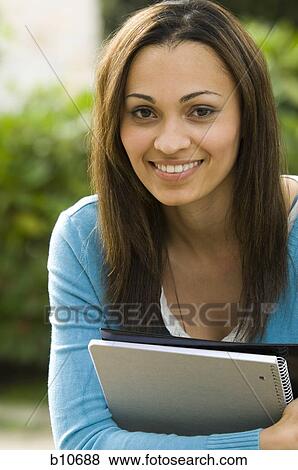 Stock Photo - College teacher giving a lesson in classroom. Fotosearch