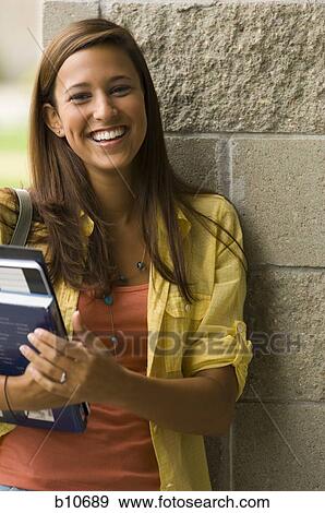 Stock Photo - College teacher giving a lesson in classroom. Fotosearch
