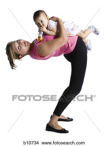 Picture - Contortionist mother with baby daughter. Fotosearch