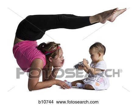 Picture - Contortionist mother with baby daughter. Fotosearch
