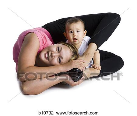 Contortionist mother with baby daughter View Large Photo Image Stock Image - Contortionist mother with baby daughter. Fotosearch