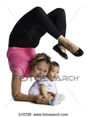 Contortionist mother with baby daughter View Large Photo Image Stock Photo - Contortionist mother with baby daughter. Fotosearch