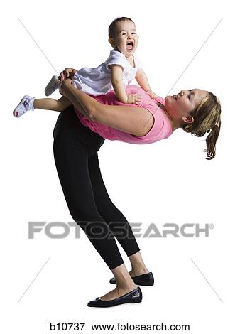Contortionist mother with baby daughter View Large Photo Image Stock Photo - Contortionist mother with baby daughter. Fotosearch