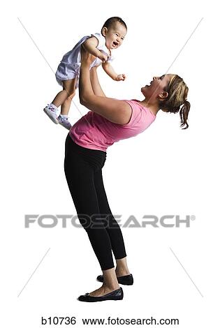 Stock Photograph - Contortionist mother with baby daughter. Fotosearch