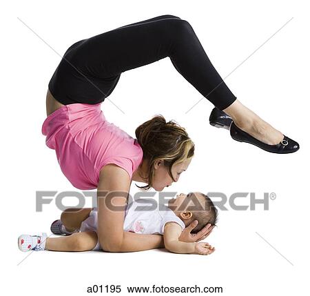 Stock Photography - Contortionist mother with baby daughter. Fotosearch