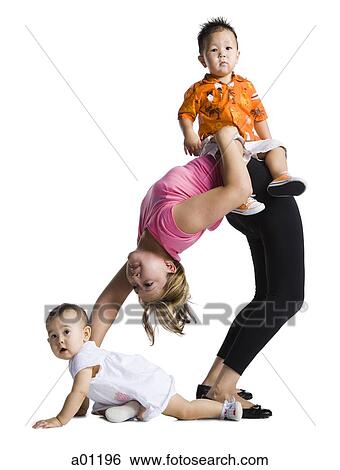 Stock Photograph - Contortionist mother with son and baby daughter. Fotosearch