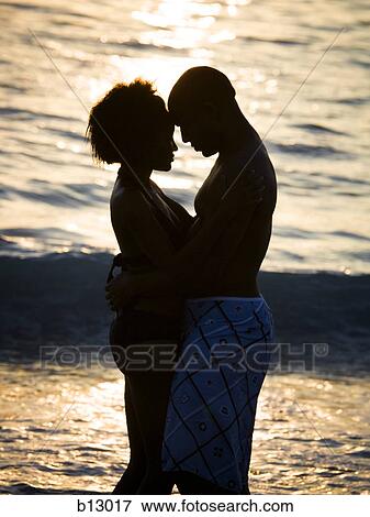 Couple embracing on beach View Large Photo Image Stock Photo - Couple embracing on beach. Fotosearch