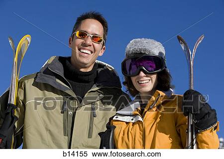 Stock Photography - Couple skiing. Fotosearch