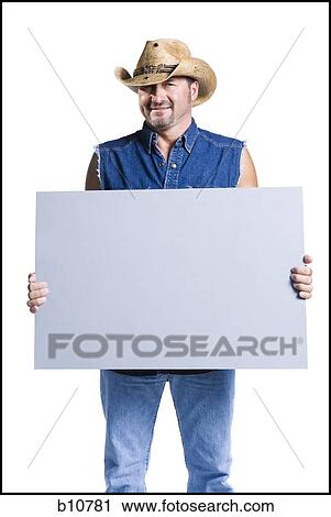 Cowboy holding blank sign View Large Photo Image Stock Image - Cowboy holding blank sign. Fotosearch