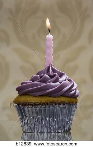 Cupcake with one birthday candle View Large Photo Image Stock Photo - Cupcake with one birthday candle. Fotosearch